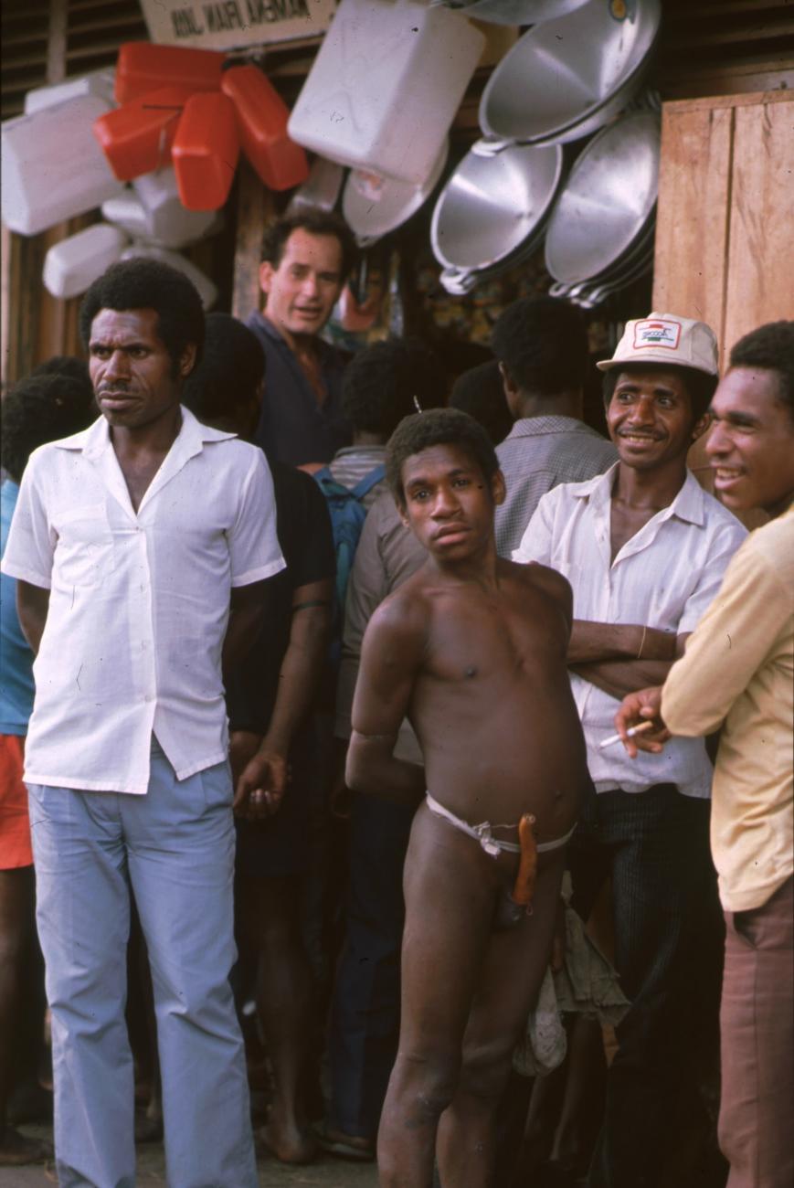 BD/166/285 -
Papua men in front of a store with pots and jerrycans