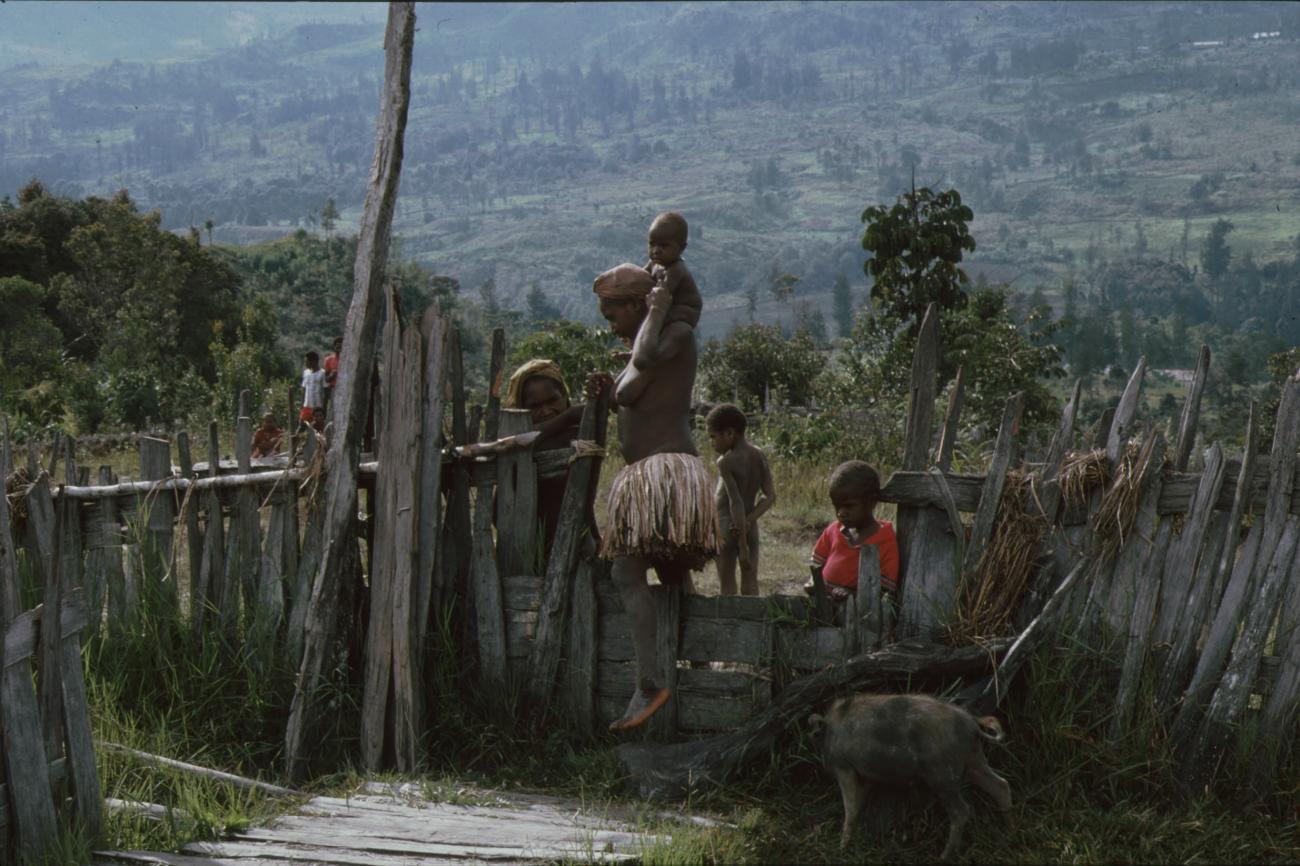 BD/166/362 -
Mother with children crossing a fence