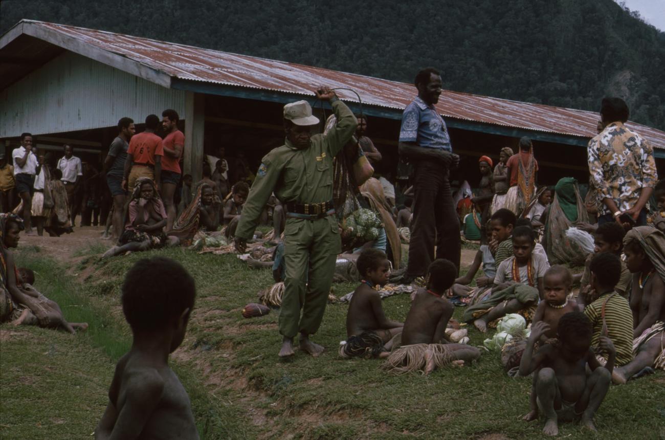 BD/166/47 -
Man in green overall in the market