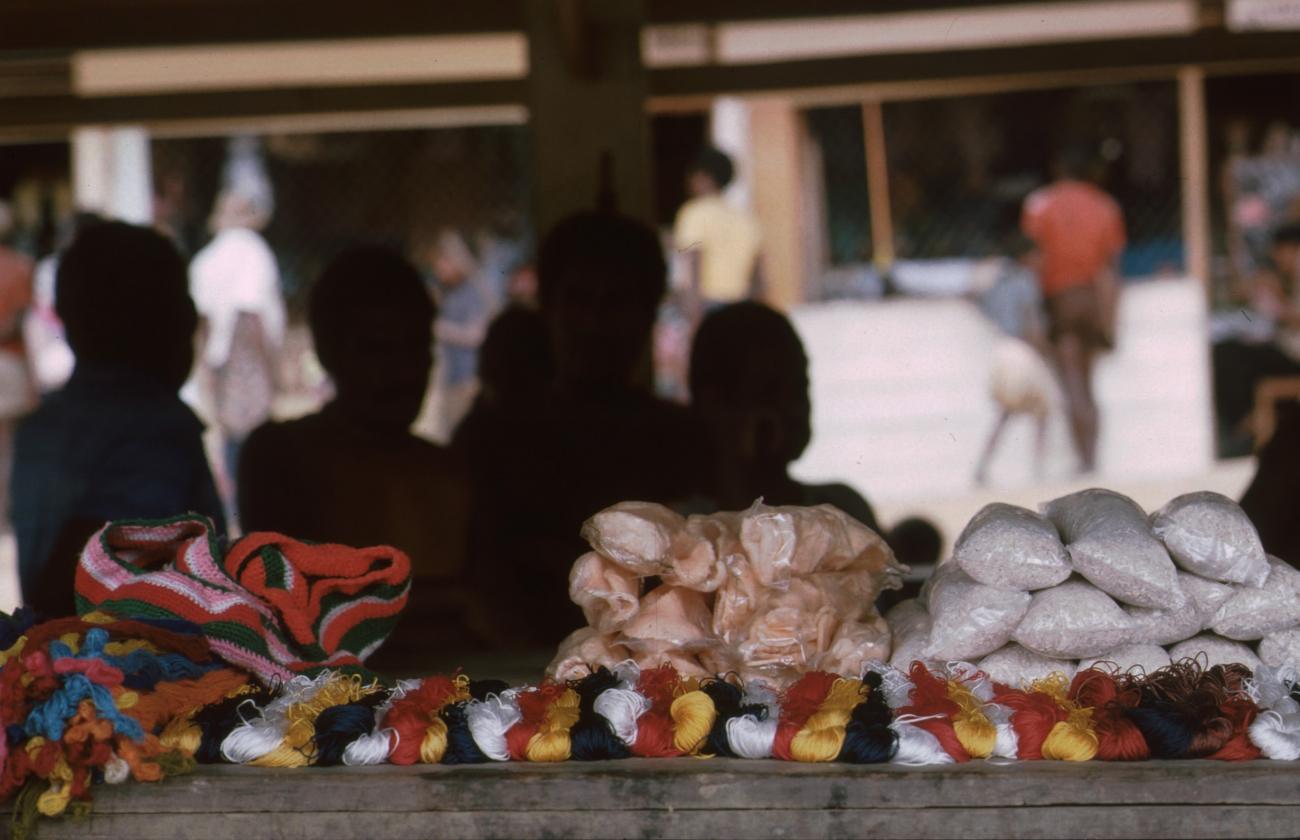 BD/166/73 -
Textile and packaged food is displayed on the covered market