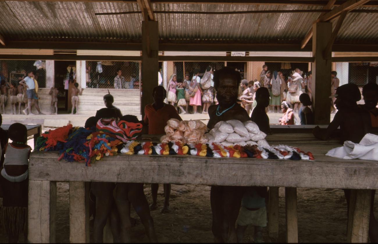 BD/166/74 -
Textile and packaged food is displayed on covered market 2