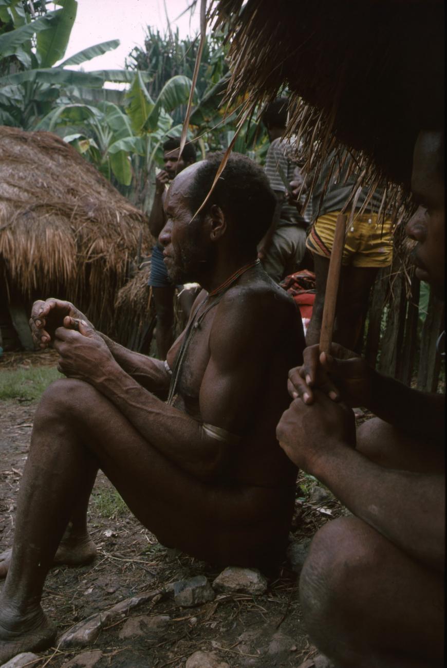 BD/166/79 -
Man sitting on a row of stones 2