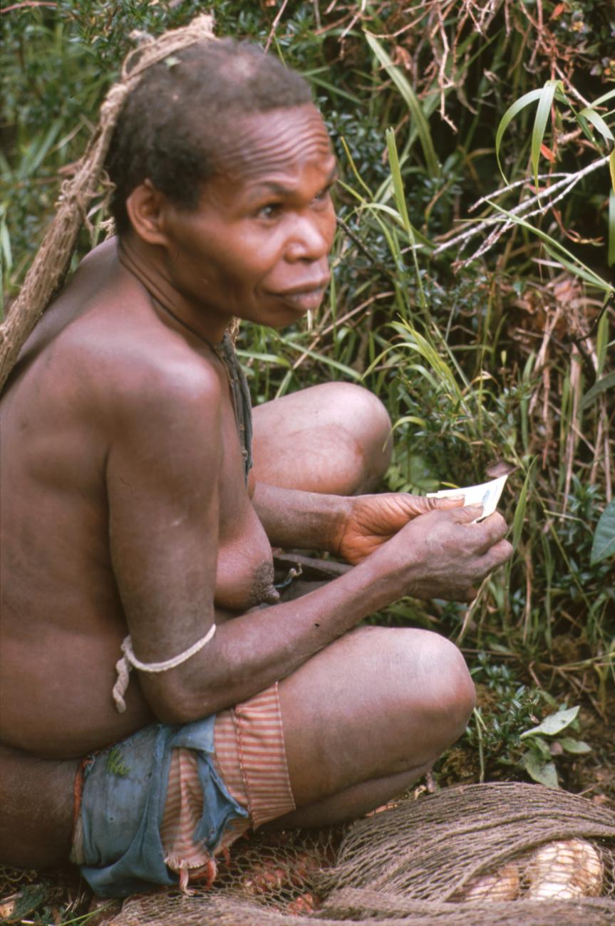 BD/166/87 -
Woman crouching in the grass