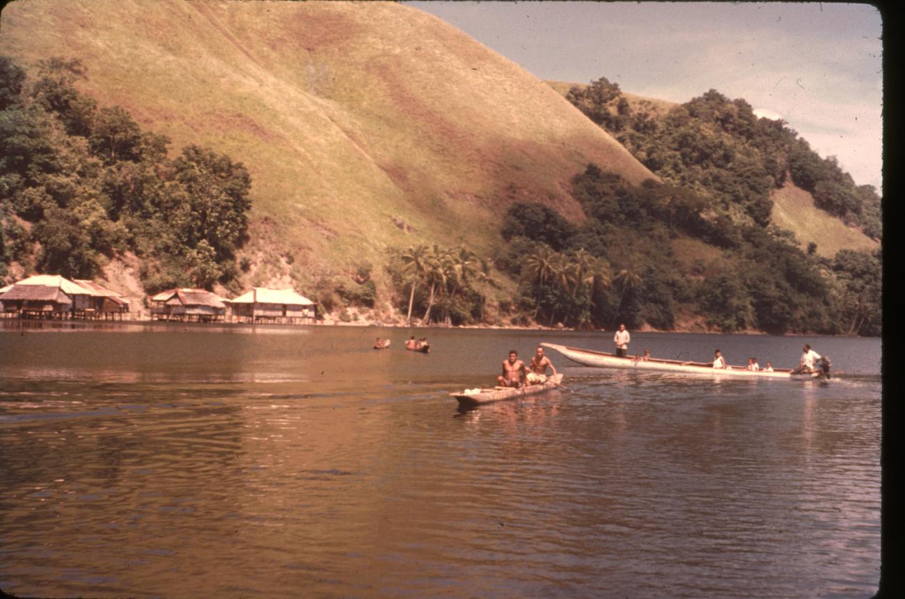 BD/67/197 -
Small boats on the water, a village in the background