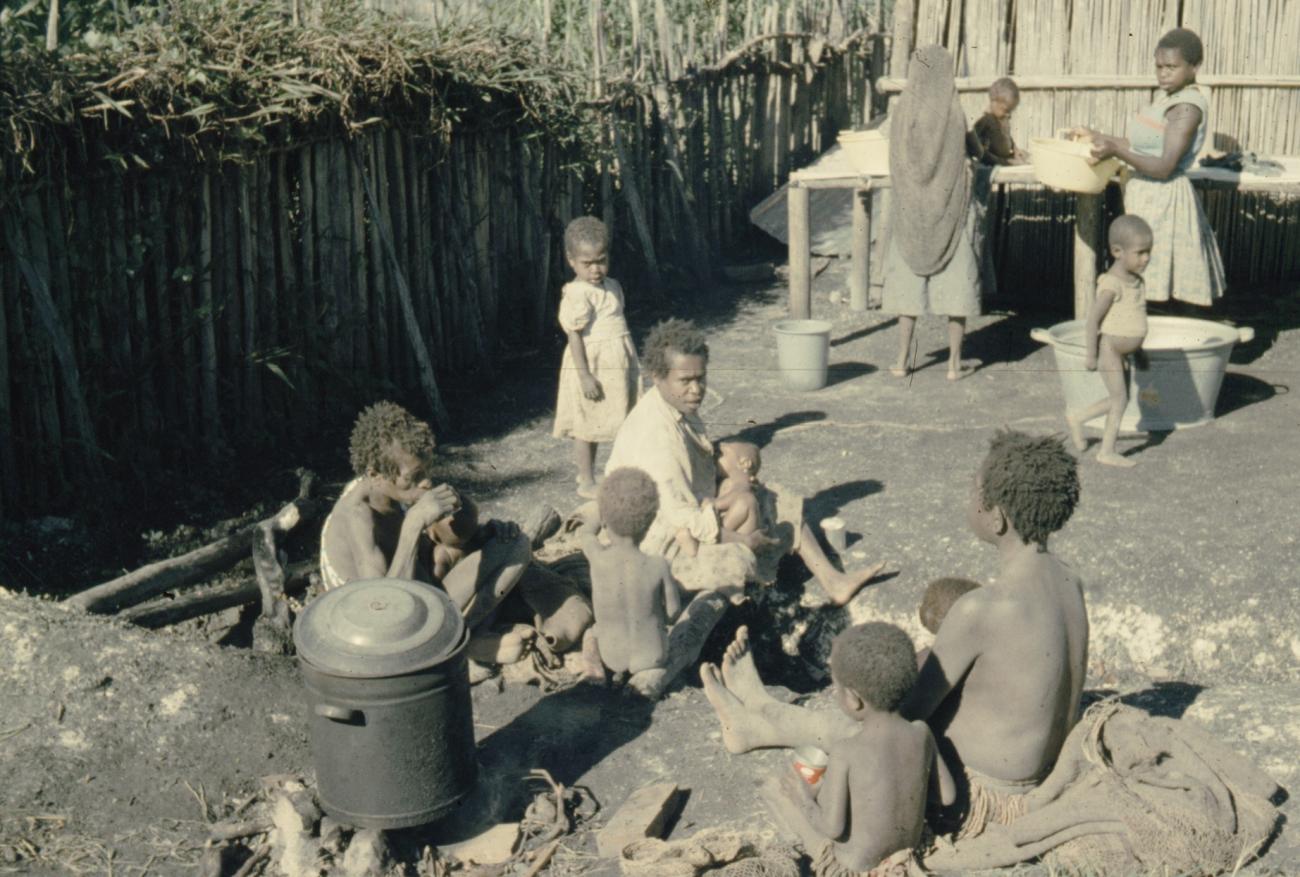 BD/285/86 - 
Ekari-vrouwen maken kinderen schoon en vrouw voedt baby
