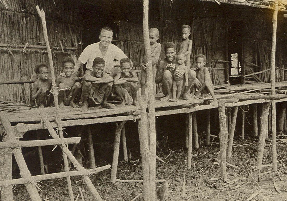 BD/269/1137 - 
Franciscaans broeder Henk Blom met Asmat op de veranda van een hunner woningen
