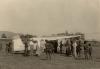 BD/269/1229 Franciskaner broeders, zuster en papoea's verzameld rondom Cessna